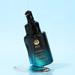 Blue skincare serum bottle with dropper on a light blue background